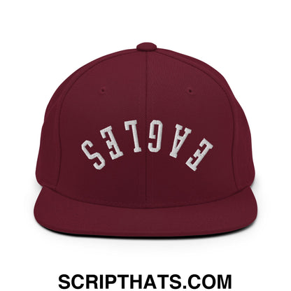 Maroon snapback hat with flat bill brim featuring white embroidered eagles lettering in an arched design