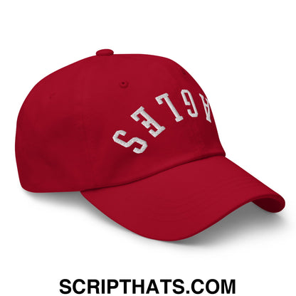 Red unstructured dad hat with white embroidered ages lettering featuring upside down eagles design