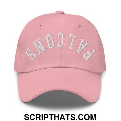 A soft pink unstructured dad hat with upside down falcons embroidered in curved silver thread across the front