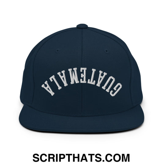 Navy blue snapback hat with white embroidered guatemala in arched lettering and flat bill brim design