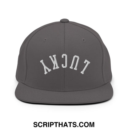 Gray snapback cap with white embroidered lucky lettering in an arched design and flat bill brim