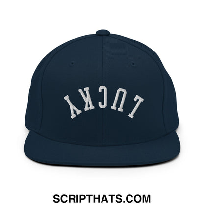 Navy blue snapback cap with white embroidered lucky lettering in an arched design and flat bill brim