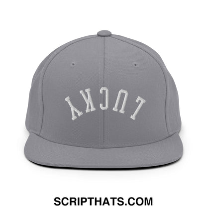 Gray snapback hat with white embroidered lucky lettering in arched design and flat bill brim for casual wear