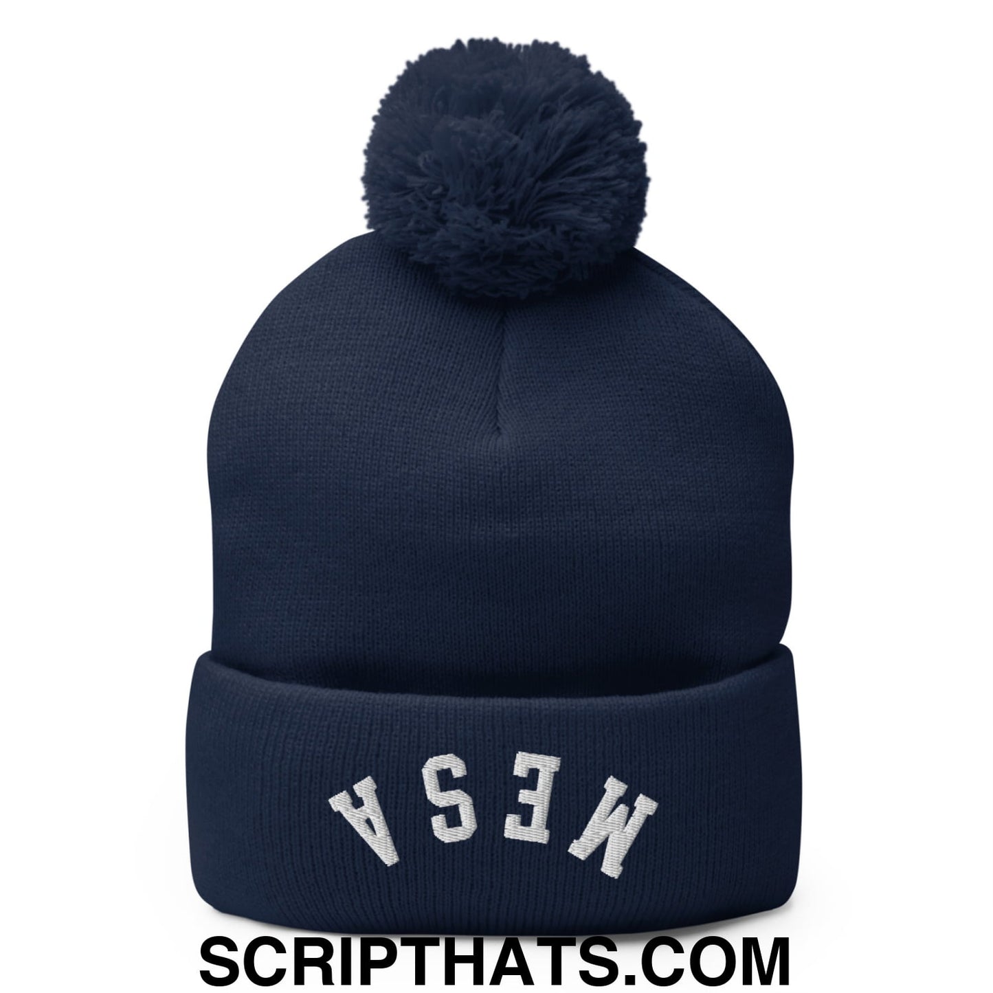 Navy blue knit beanie with matching pom pom and white embroidered mesa lettering on the cuff