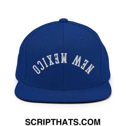 Royal blue snapback hat with white embroidered new mexico lettering in an arched design and flat bill brim