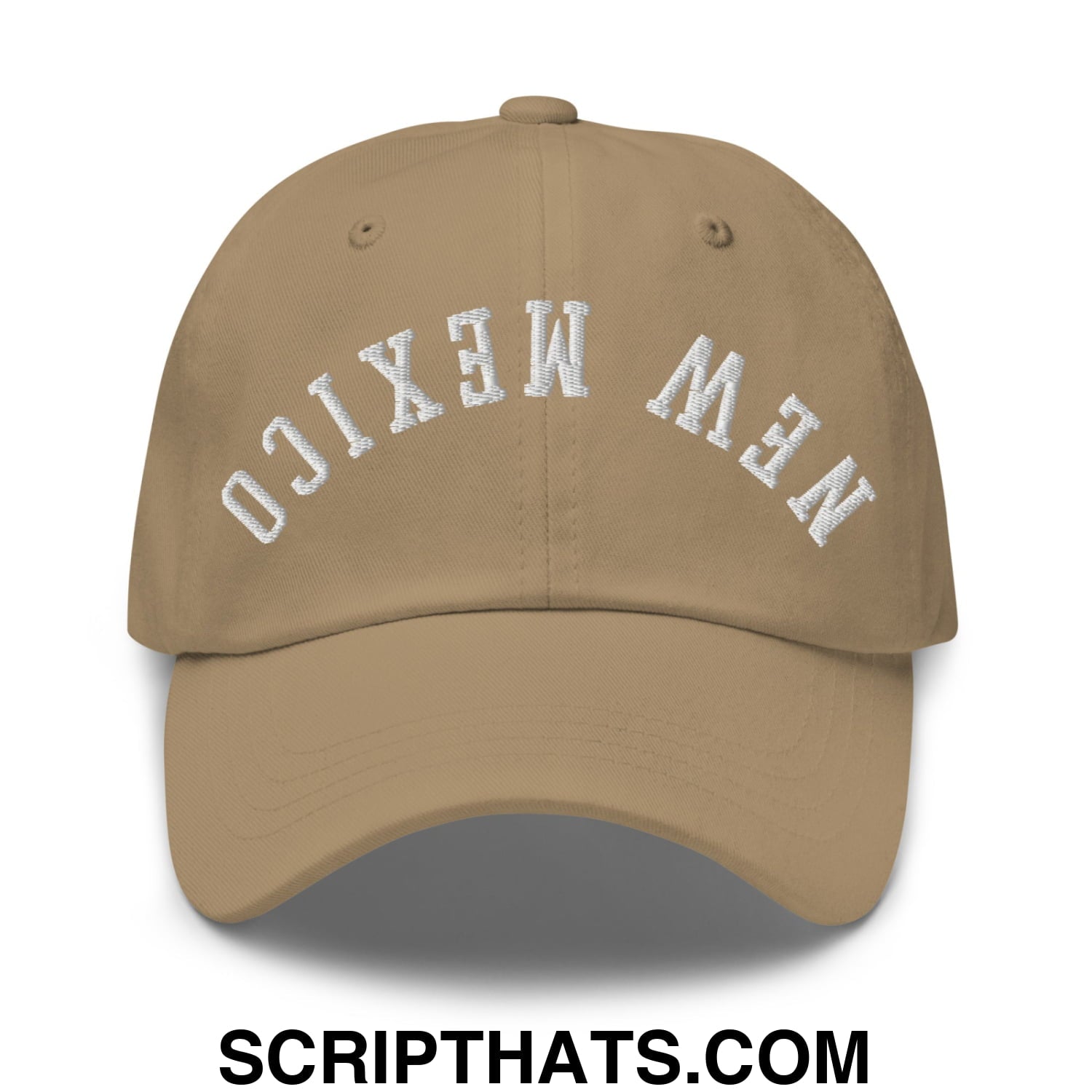 Tan unstructured dad hat with white embroidered new mexico lettering in an arched design on front panel