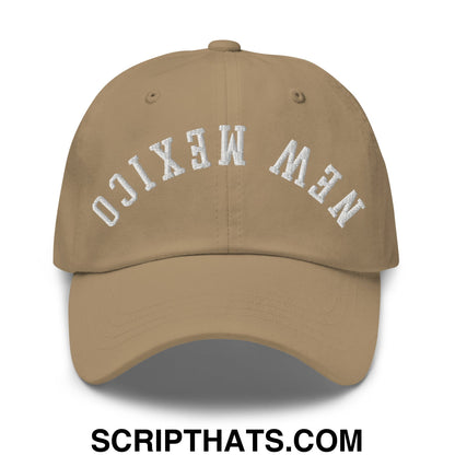 Tan unstructured dad hat with white embroidered new mexico lettering in an arched design on front panel
