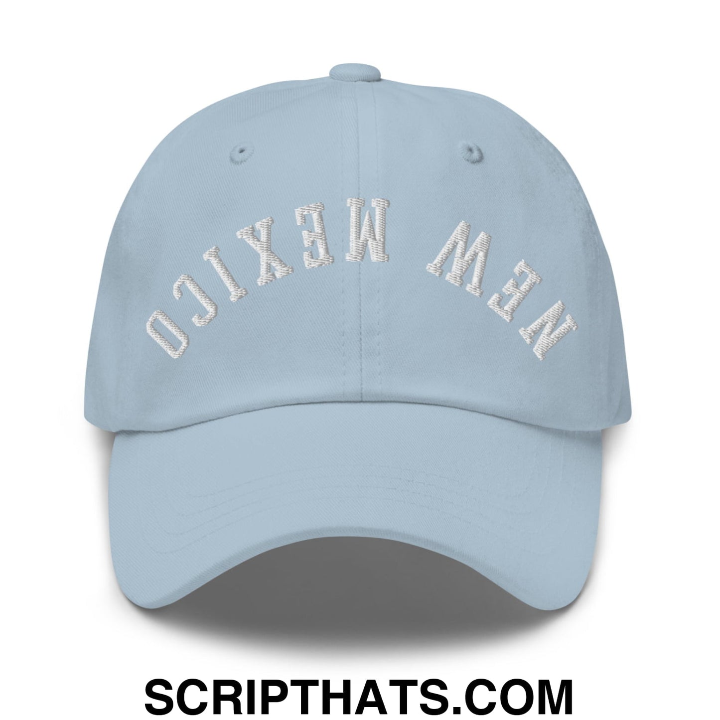 Light blue unstructured dad hat with new mexico embroidered in white arched lettering on the front