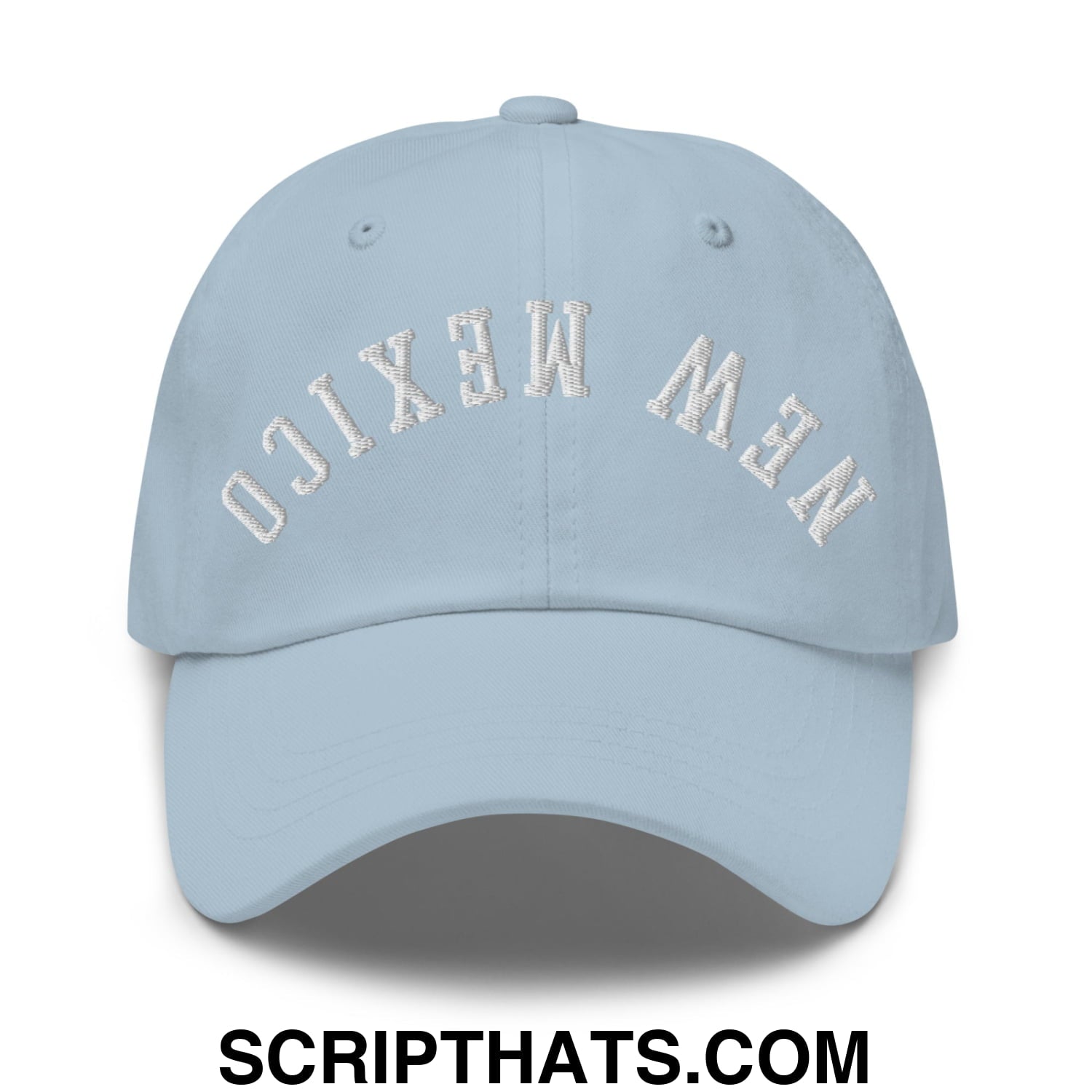 Light blue unstructured dad hat with new mexico embroidered in white arched lettering on the front