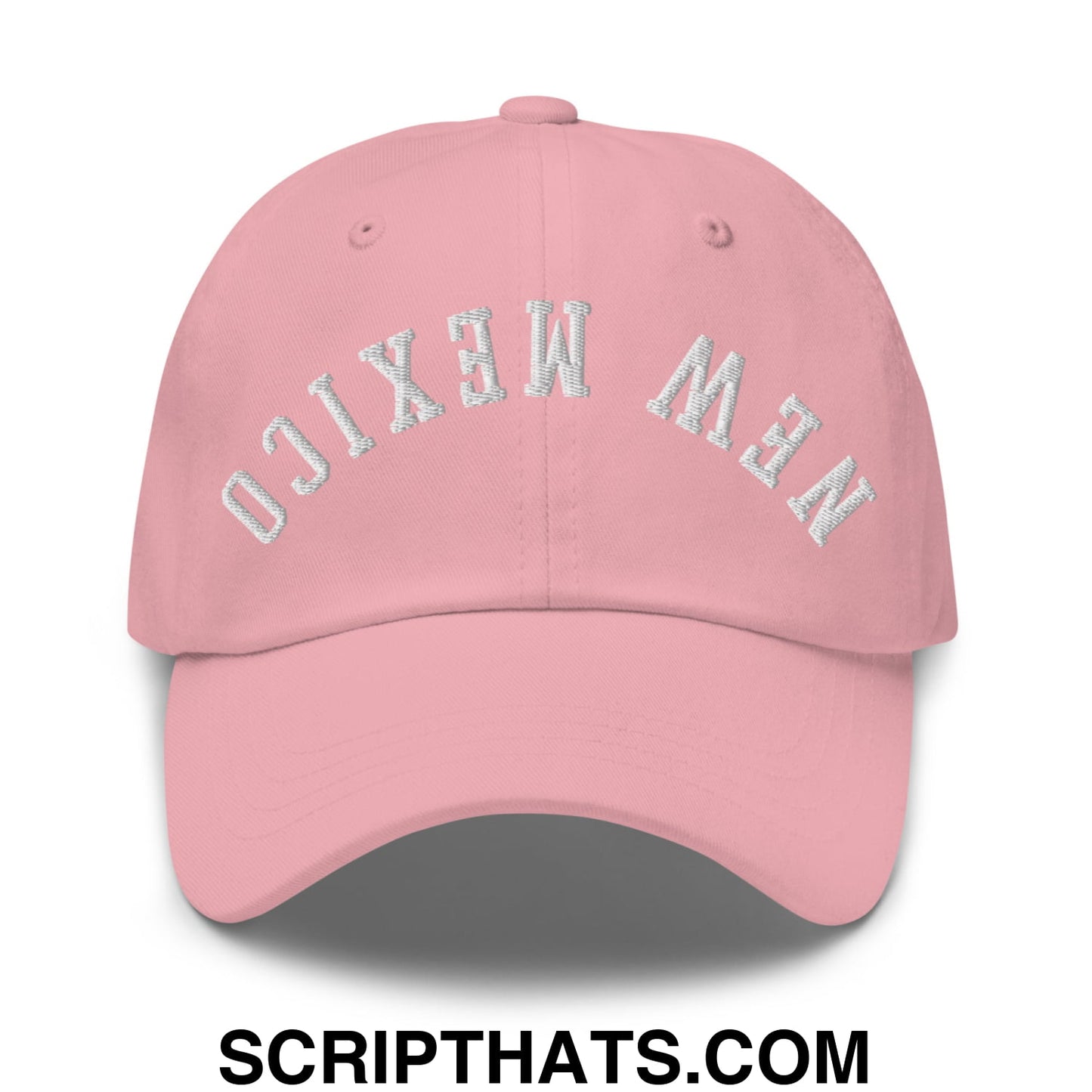 A soft pink unstructured dad hat with new mexico embroidered in silver thread on the front