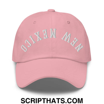 A soft pink unstructured dad hat with new mexico embroidered in silver thread on the front