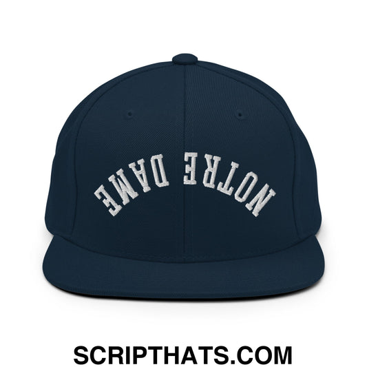 Navy blue snapback hat with white embroidered upside down Notre Dame arch logo and flat bill brim design