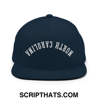 Navy blue snapback hat with white arched north carolina embroidery and flat bill brim in upside down style