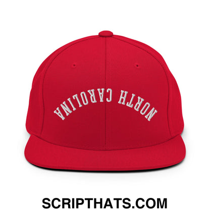 Red snapback cap with white embroidered north carolina text in an arched design and flat bill brim