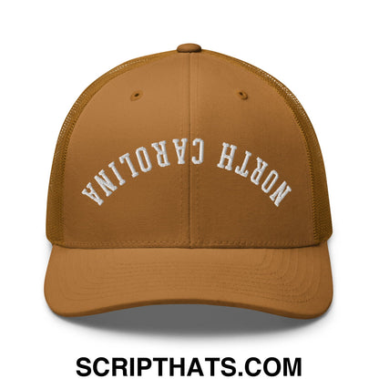 A tan mesh trucker hat with white embroidered north carolina lettering on the front panel