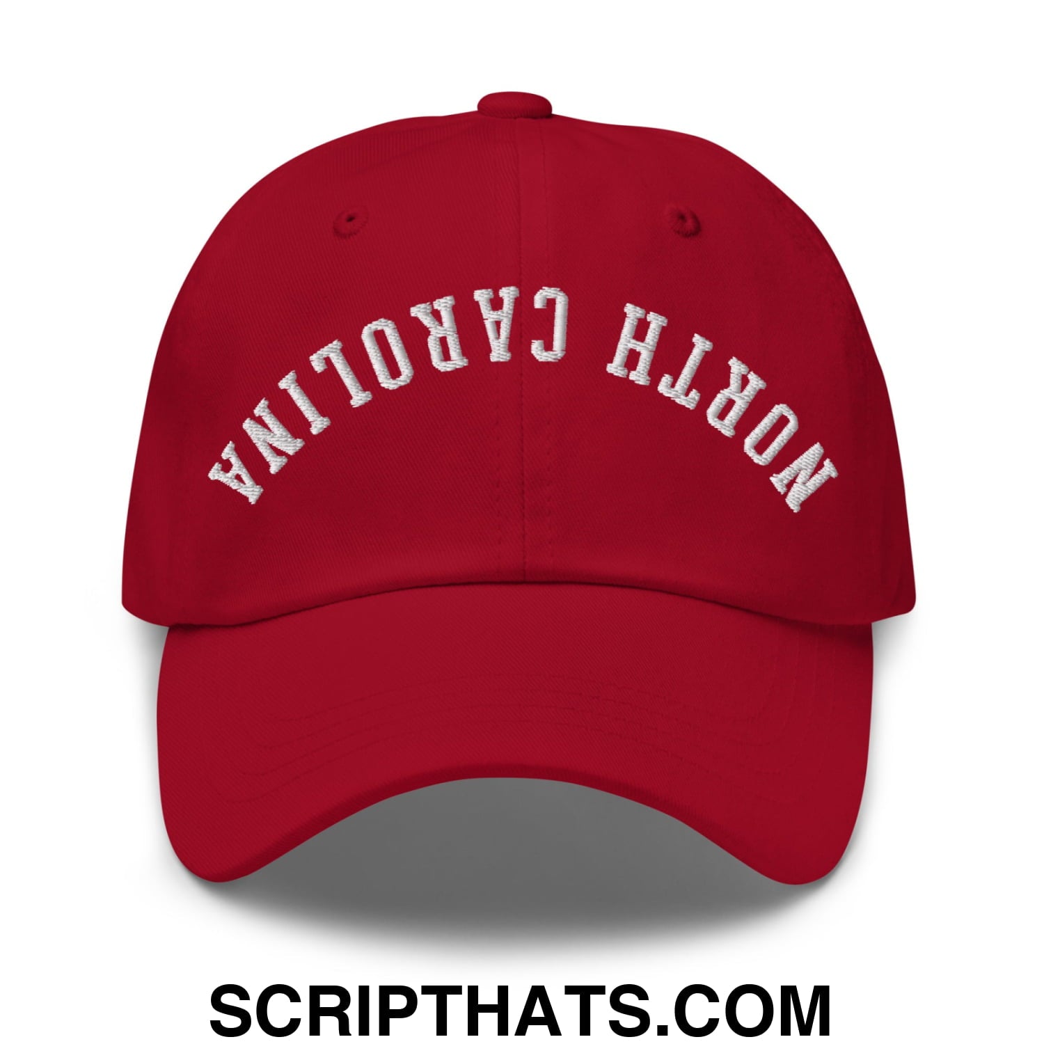 Red unstructured dad hat with white embroidered north carolina text in an arched design upside down style