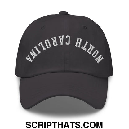 Black unstructured dad hat with white embroidered north carolina text in an arched design titled upside down north carolina hat
