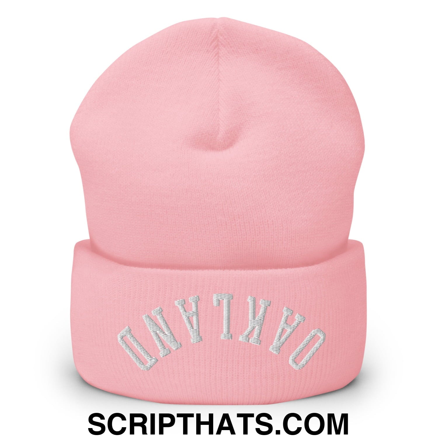 A soft pink knit cuffed beanie embroidered with oakland in silver thread, perfect for cold weather