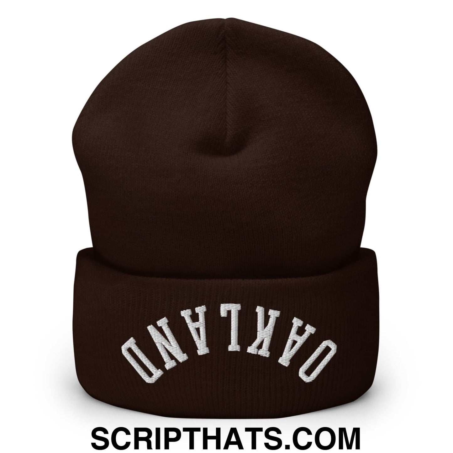 A dark brown knit cuffed beanie embroidered with white upside down oakland text on the folded brim