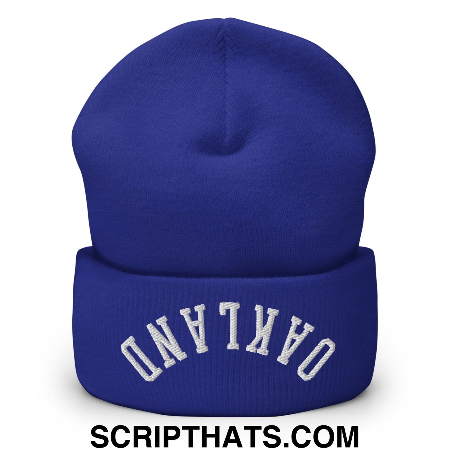 Royal blue knit beanie with white arched Oakland embroidery on folded cuff in upside down embroidered cuffed style