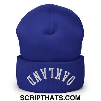 Royal blue knit beanie with white arched Oakland embroidery on folded cuff in upside down embroidered cuffed style