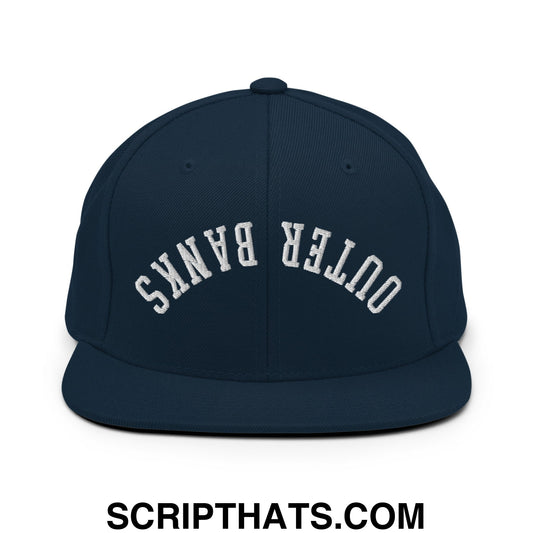 Navy blue snapback hat with white embroidered outer banks text and flat bill brim in an upside down design