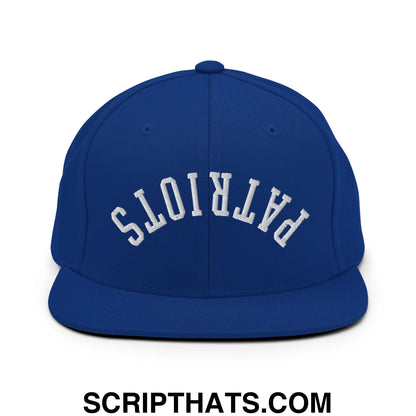 Royal blue snapback cap with white embroidered patriots lettering in arched design and flat bill brim