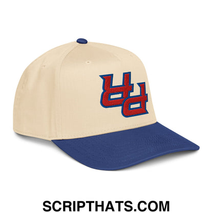 Beige and navy blue baseball snapback hat with a red and blue embroidered uc logo from upside down pr puerto rico
