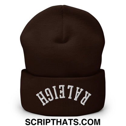 A dark brown knit beanie with raleigh embroidered in white on the folded cuff cuffed knit beanie