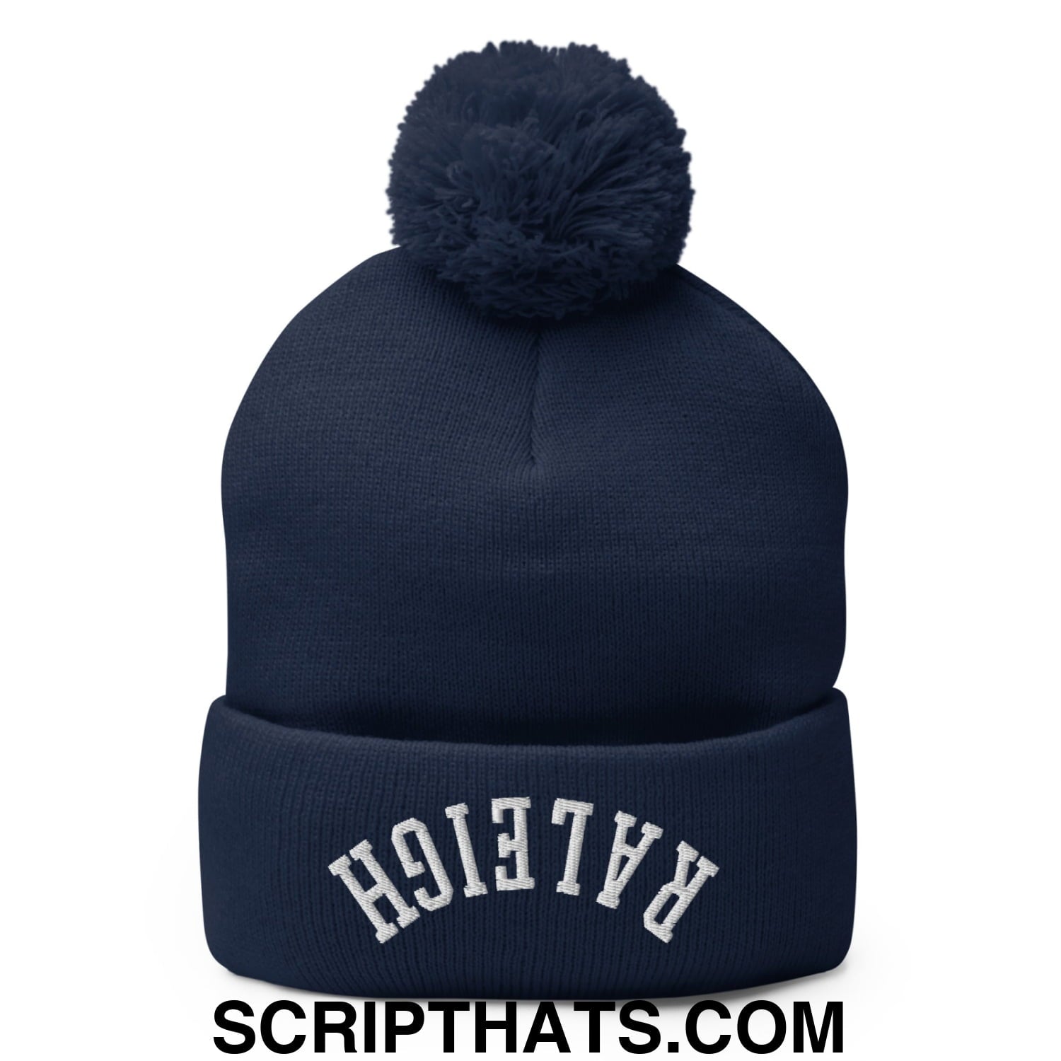 Navy blue knit beanie with a matching fluffy pom pom and white embroidered raleigh lettering on the cuff