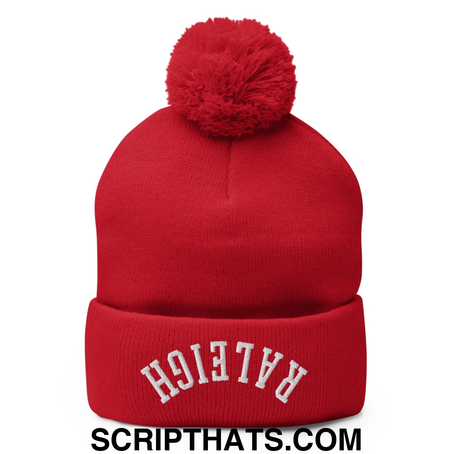 Red knit beanie with fluffy pom pom and white embroidered raleigh lettering across the cuff in upside down style