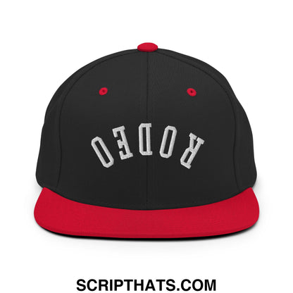 Black and red snapback hat with upside down rodeo embroidered in white on a flat bill brim design