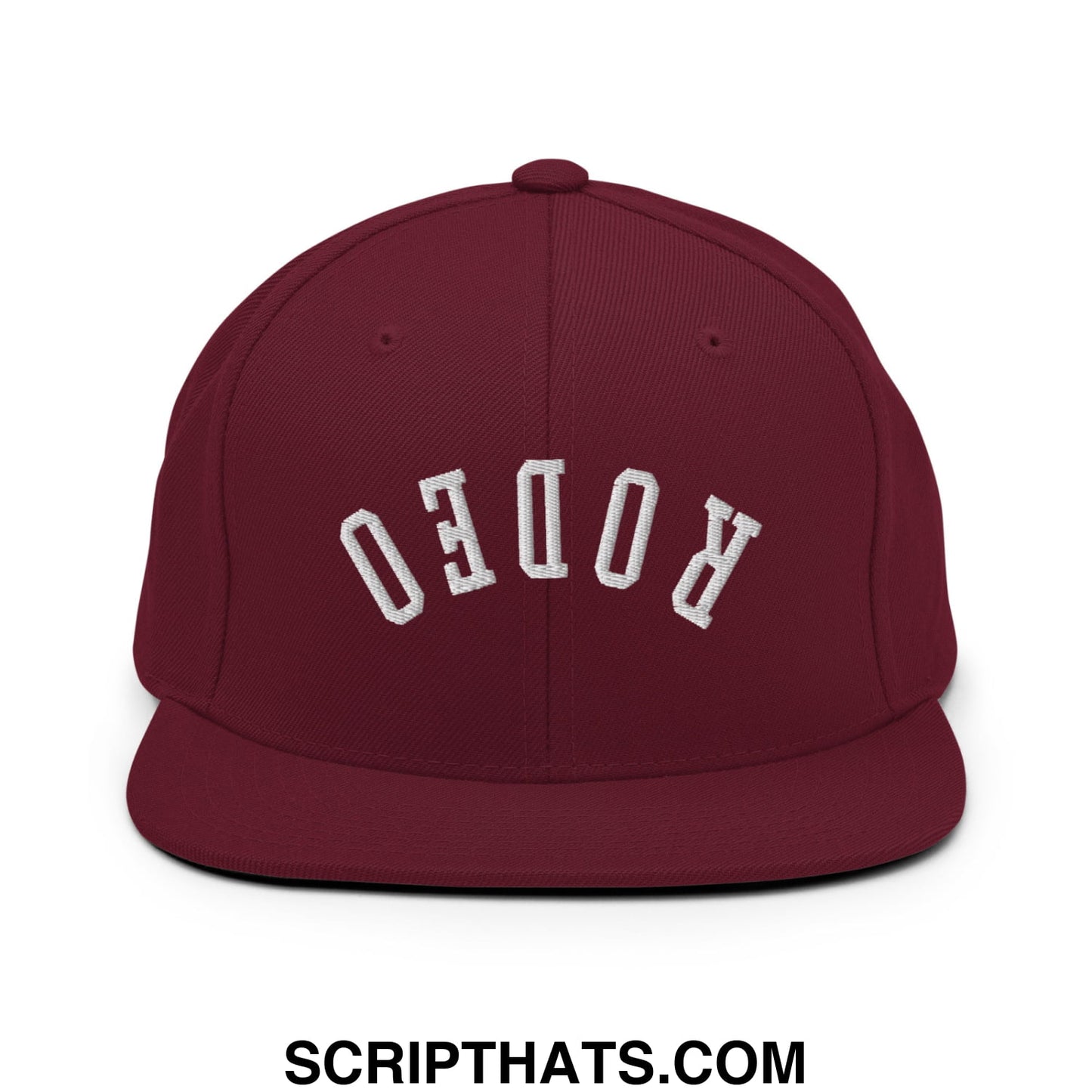 Maroon snapback hat with white embroidered rodeo lettering in an arched design and flat bill brim