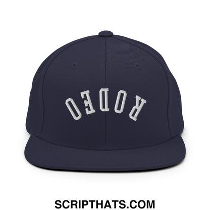 Navy blue snapback hat with white embroidered rodeo lettering and flat bill brim for casual wear