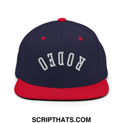 Navy blue and red snapback hat with white embroidered rodeo flat bill brim in upside down rodeo design