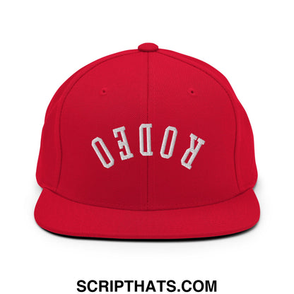 Red snapback cap with white embroidered rodeo lettering and flat bill brim for casual streetwear style