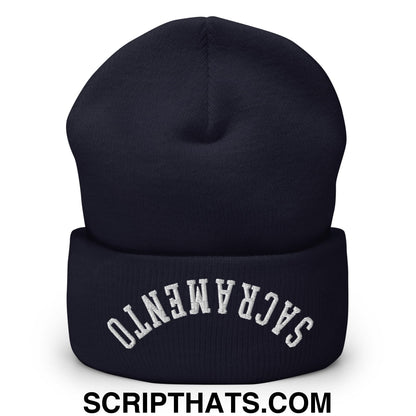 A navy blue knit beanie with a folded cuff and white upside down Sacramento embroidery on the front