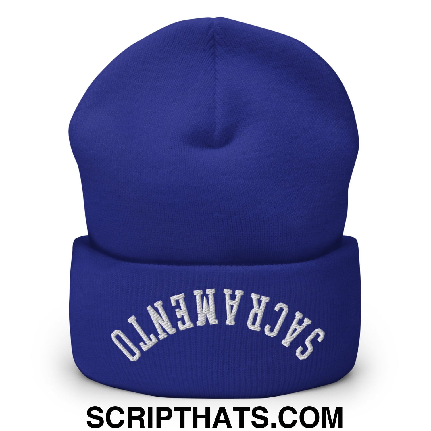 Royal blue knit beanie with white embroidered sacramento on the folded cuff featuring upside down design