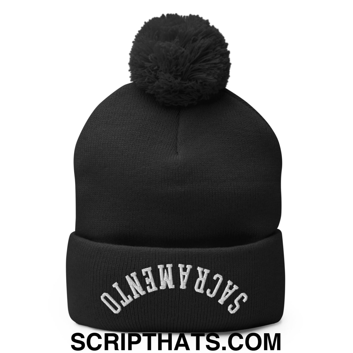 Black knit beanie with fluffy black pom pom and white embroidered Sacramento on cuff for cold weather use
