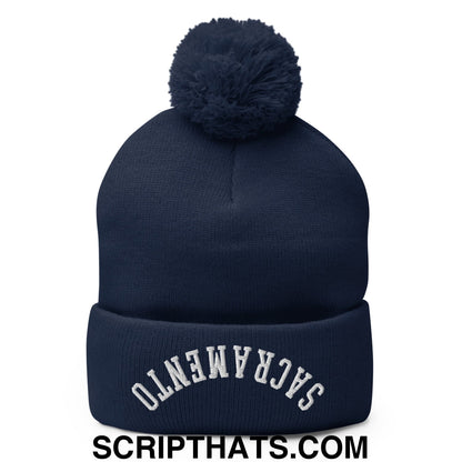Navy blue knit beanie with matching pom pom and white embroidered sacramento arch on cuff in upside down style