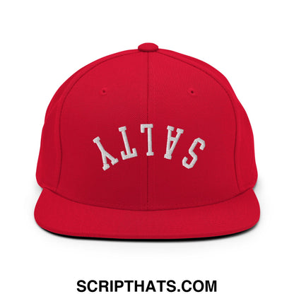 A vibrant red snapback hat with white embroidered salty lettering in an arched design on a flat bill brim