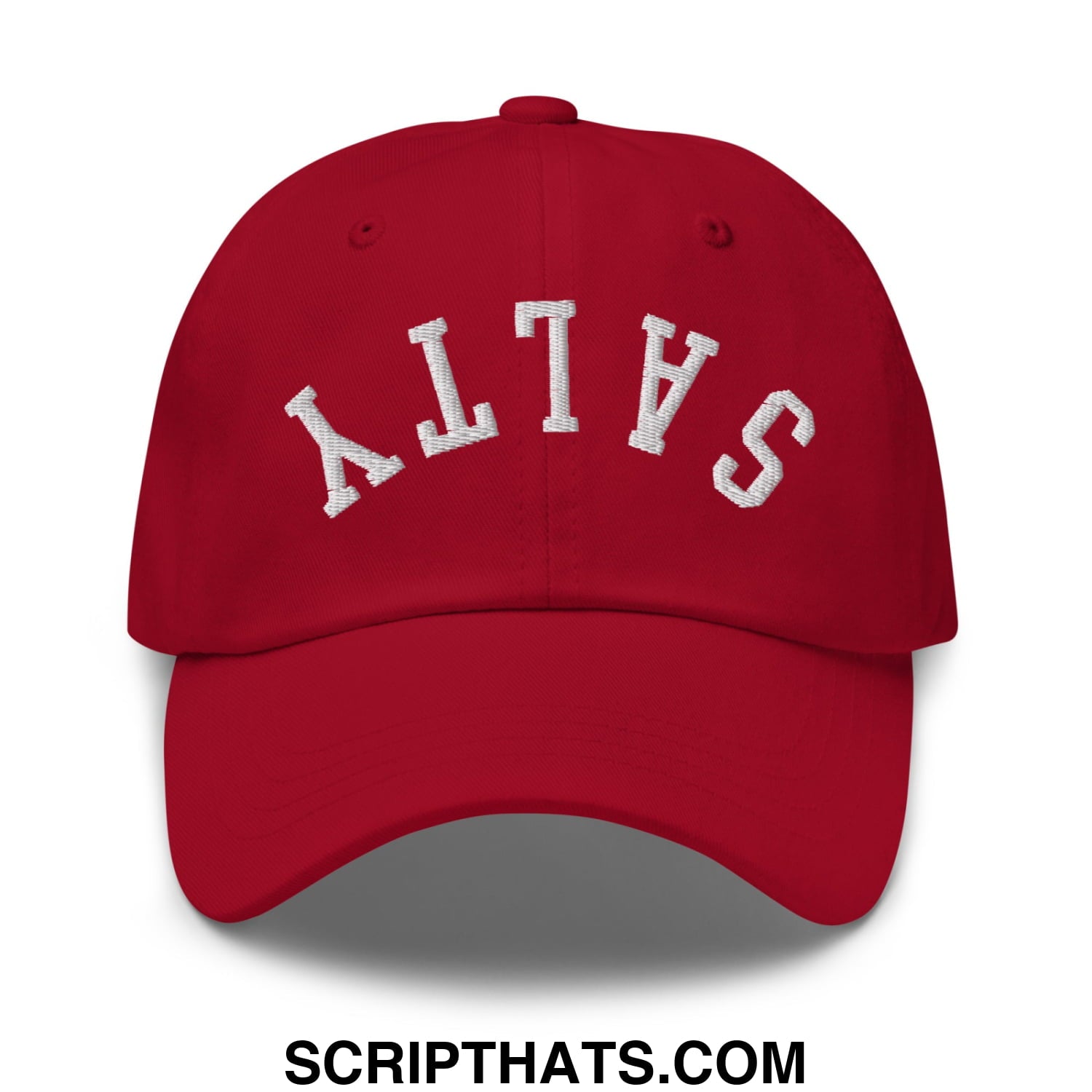 Red unstructured dad hat featuring white embroidered salty lettering in an arched design called upside down salty