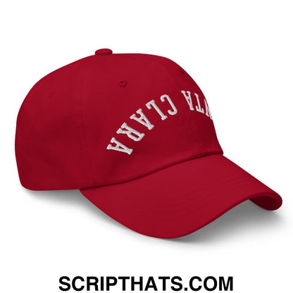 Red unstructured dad hat with white embroidered ntra clara lettering upside down santa clara design