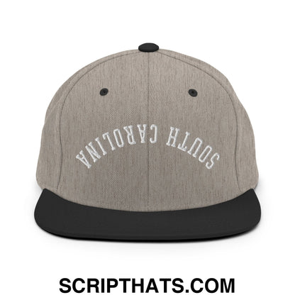 Gray and black snapback hat with upside down south Carolina embroidered in white arched lettering on flat bill brim