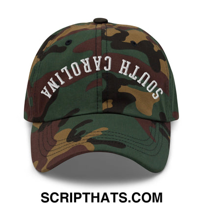 A camouflage pattern unstructured dad hat with south carolina embroidered in white across the front