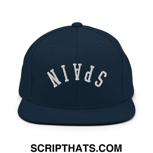 Navy blue snapback hat with white embroidered spain lettering and flat bill brim in an upside down design