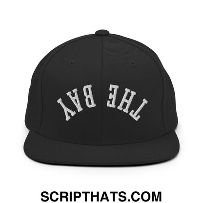 Black snapback cap with white embroidered the bay lettering in a classic arched design and flat bill brim