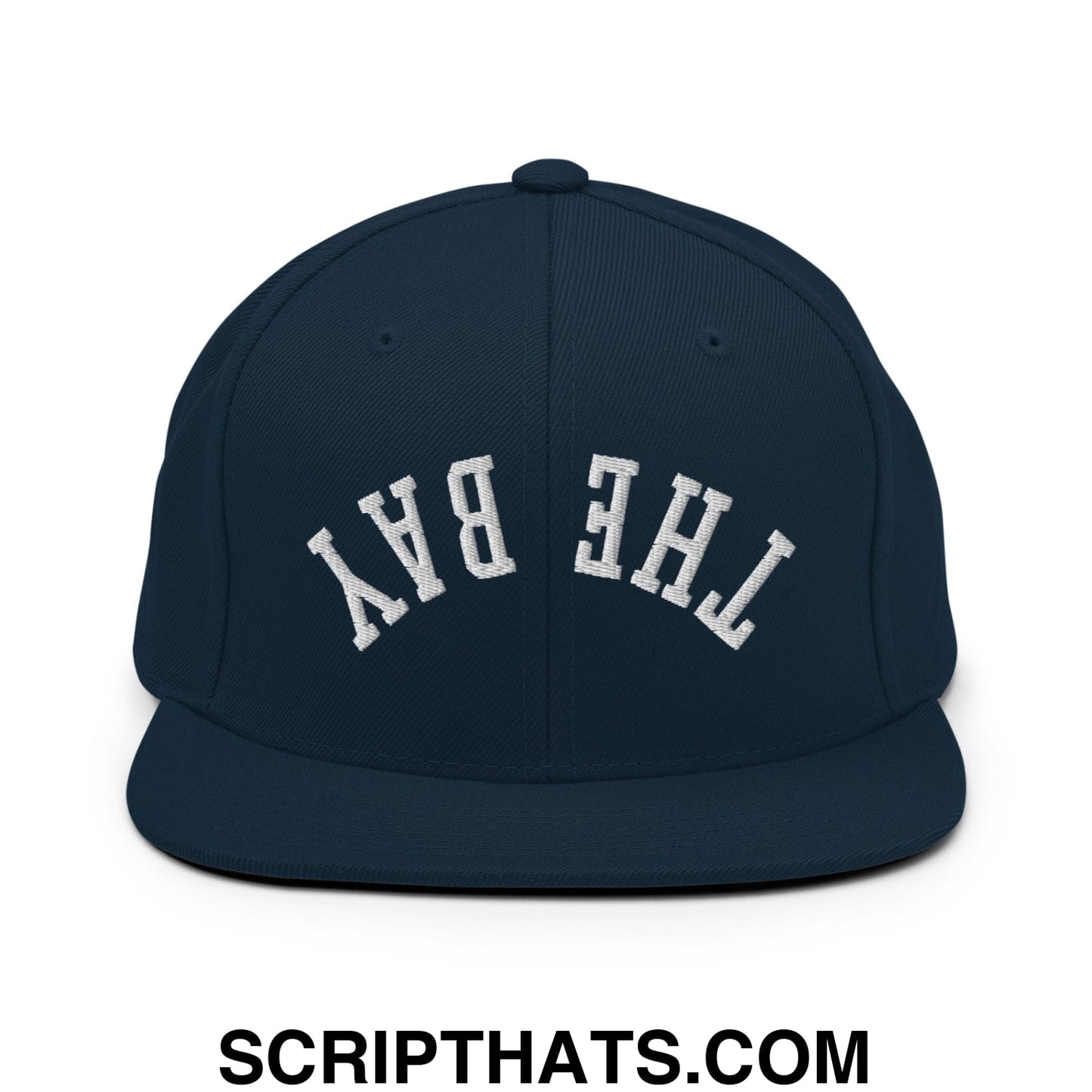 Navy blue snapback hat with white embroidered the bay lettering in classic arched design and flat bill brim