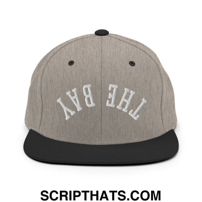 Gray heather snapback cap with black flat bill brim and white embroidered the bay lettering in front