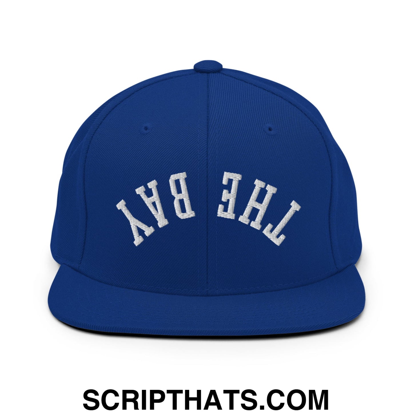 Royal blue snapback hat with white embroidered the bay lettering and flat bill brim in classic arched design